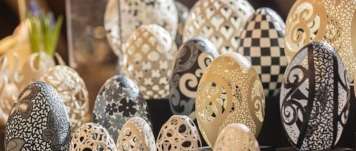 an exhibition table with many different engraved, drilled and milled eggshells